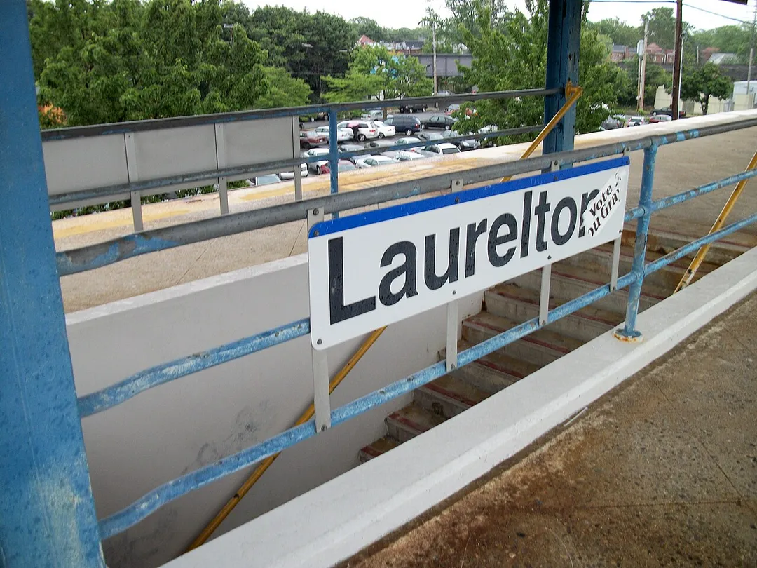 An image of one of the staircases in the center platform of Laurelton (LIRR station), in Laurelton, Queens, New York City. The Montauk Line can be seen in the background, and the right-of-way is about to merge with that of the Atlantic Branch to the right of this picture.