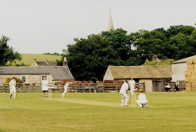 Village cricket, Ledsham. The classic English village scene on midsummer's day, 2003. All Saints church spire pokes above the trees.