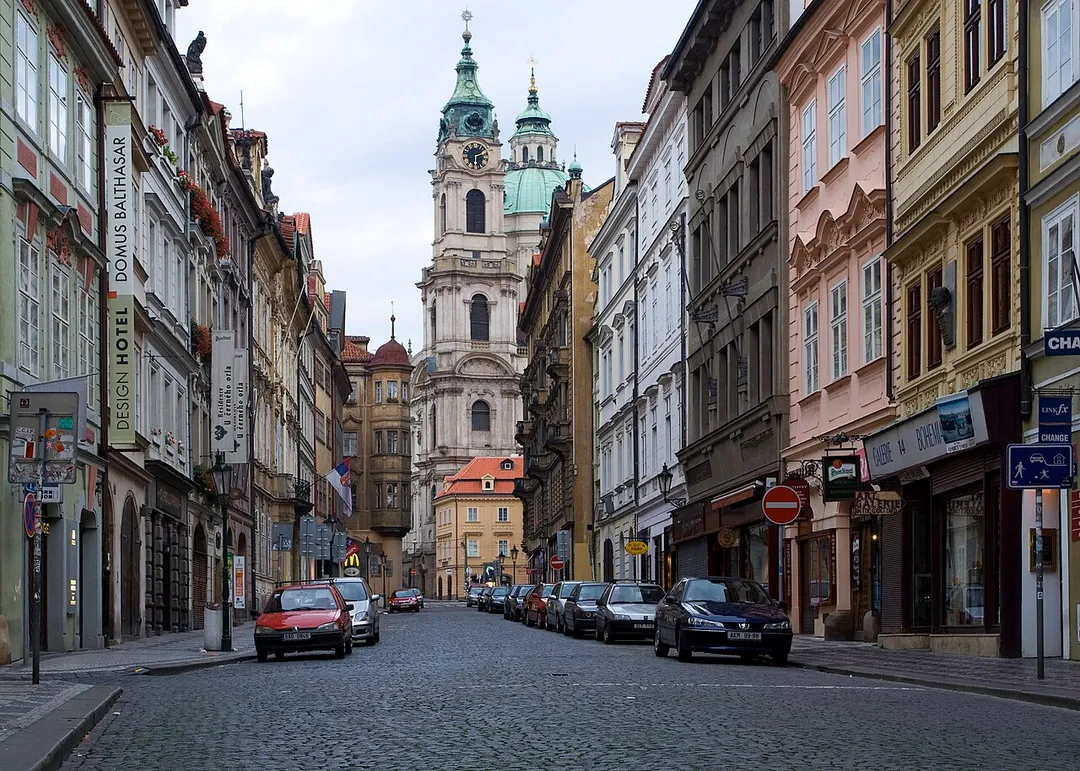 A view of the Mostecká viewed towards Malostranské Náměstí with the Church of Saint Nicolas in the background in Malá Strana, Prague just after sunrise.