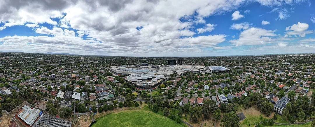 Aerial panorama of Chadstone Shopping Centre with the Dandenong Ranges on the horizon