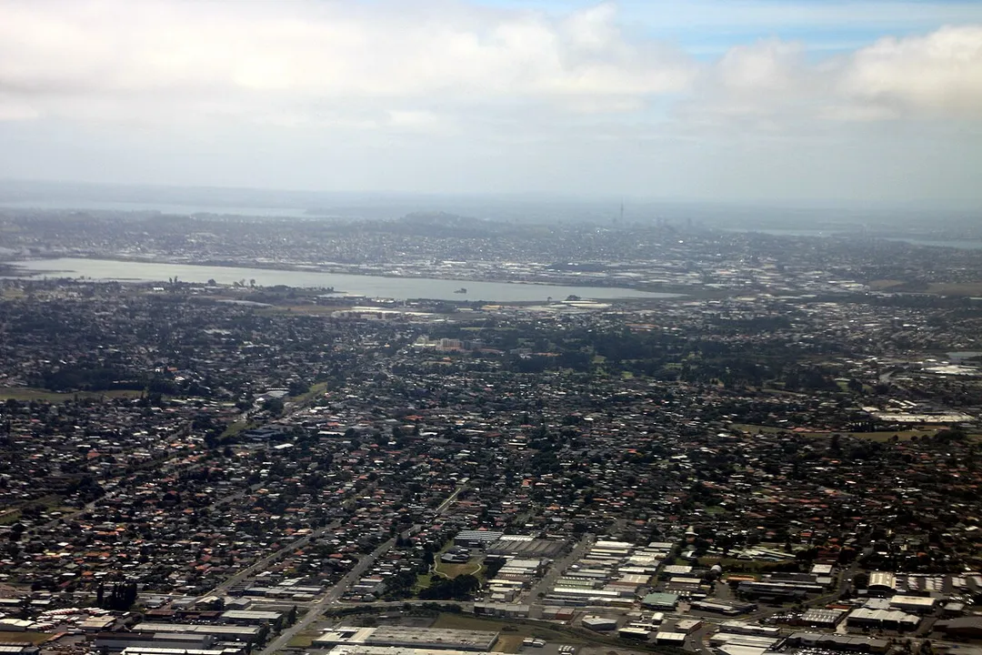 2009 aerial view of South Auckland (Mangere East and Otahuhu), looking north towards the Mangere Inlet. The Auckland CBD is in the background.