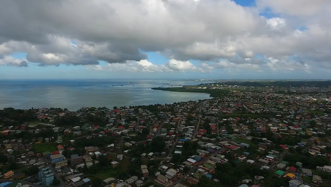 Marabella, San Fernando, Trinidad and Tobago.
In the background: The industrial areas of Pointe-à-Pierre. Top left: The Gulf of Paria. Technically Marabella is not a part of San Fernando, but it's administred by Princes Town instead. It is generally considered to be a suburb of San Fernando though.

Photo taken as part of the Southern Trinidad Aerial Photo Project, a small project sponsored by WMDE. Drone used: DJI Phantom 4. Snapshot taken from video footage via VLC.