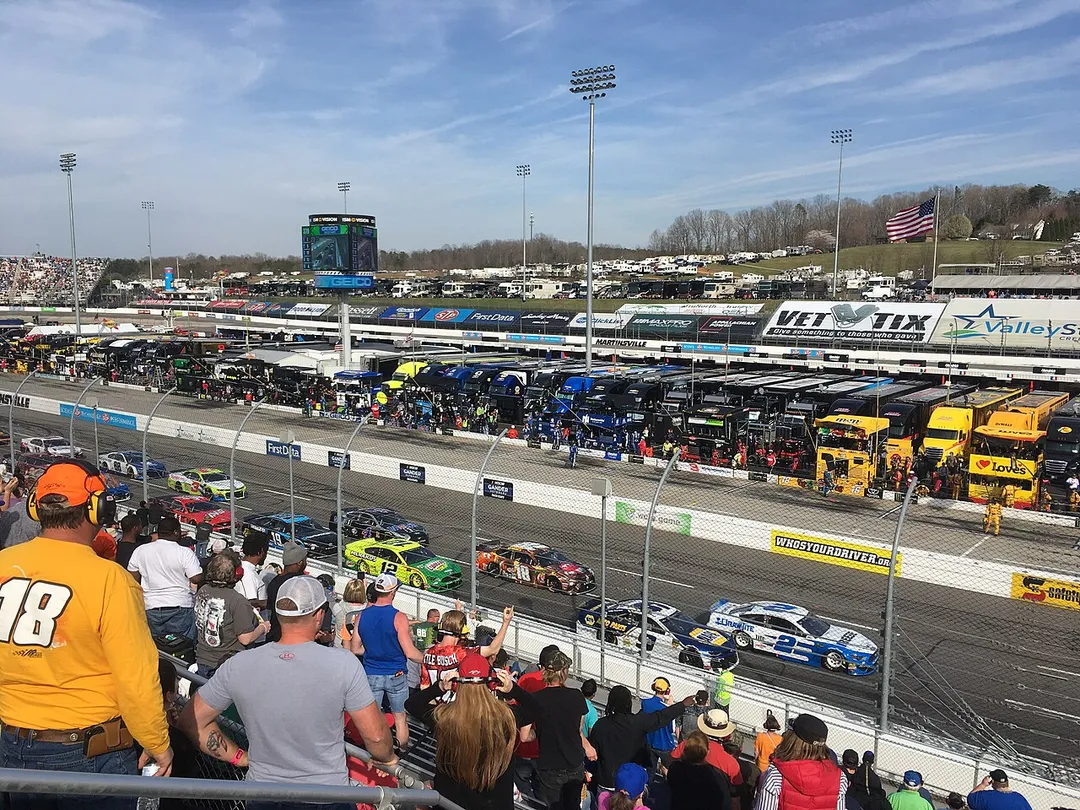 The 2019 STP 500 at Martinsville Speedway viewed from the frontstretch. Brad Keselowski (#2) leads Chase Elliott (#9), Kyle Busch (#18) and the rest of the field following a restart.