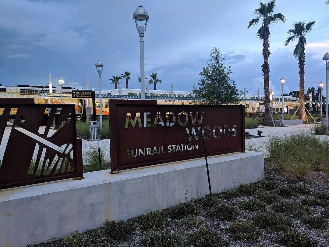 Meadow Woods station in the evening with the SunRail train in the background.
