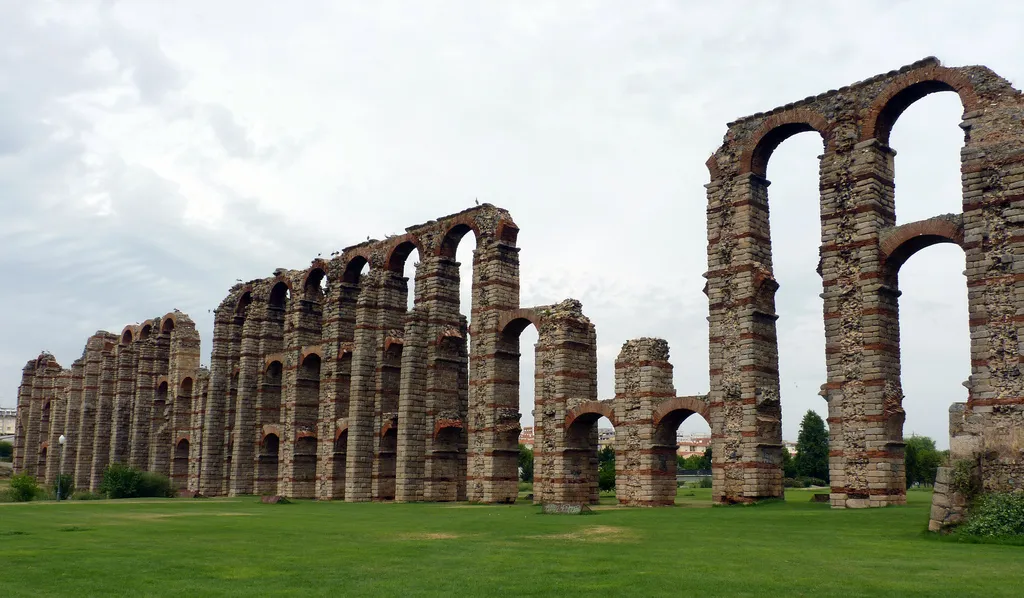 Impresionante visión del acueducto.
Arcos del acueducto romano de Los Milagros del S. I d.C. (popularmente conocido así porque es un milagro que después de casi dos mil años todavía se tenga en pié). Traía el agua a la ciudad desde el embalse de Proserpina (a unos cinco kilómetros de Emérita Augusta), salvando los accidentes naturales como por ejemplo el cauce del rio "Barraeca" de los romanos, el actual Albarregas. En su parte superior discurría el canal de la conducción, el cuál estaba cubierto para su protección (actualmente no quedan restos de él).
Sus piedras han servido, a lo largo del tiempo, como "cantera" para otras construcciones de la ciudad. Dicen los expertos que de no haber sido así hoy lo pódríamos contemplar completo y con todo su esplendor.

Edición especial para el concurso de:Wiki Loves Monuments 2011 España