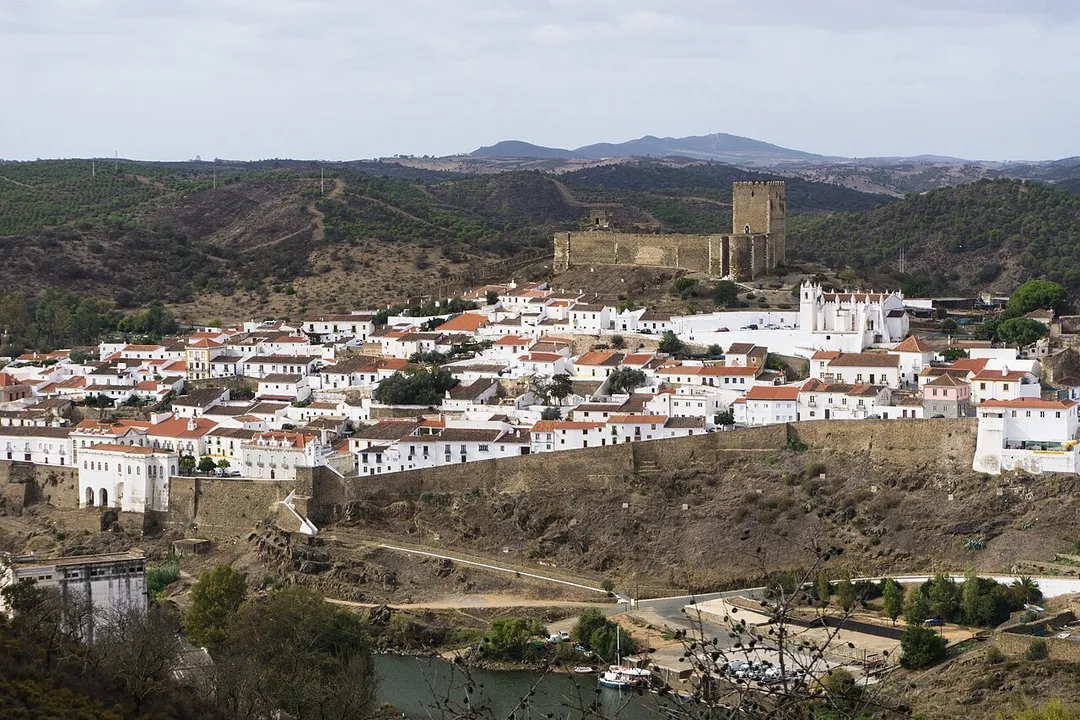 Mértola viewed from the opposite shore of the Guadiana, with the city wall and the medieval castle uphill, 10th November 2019