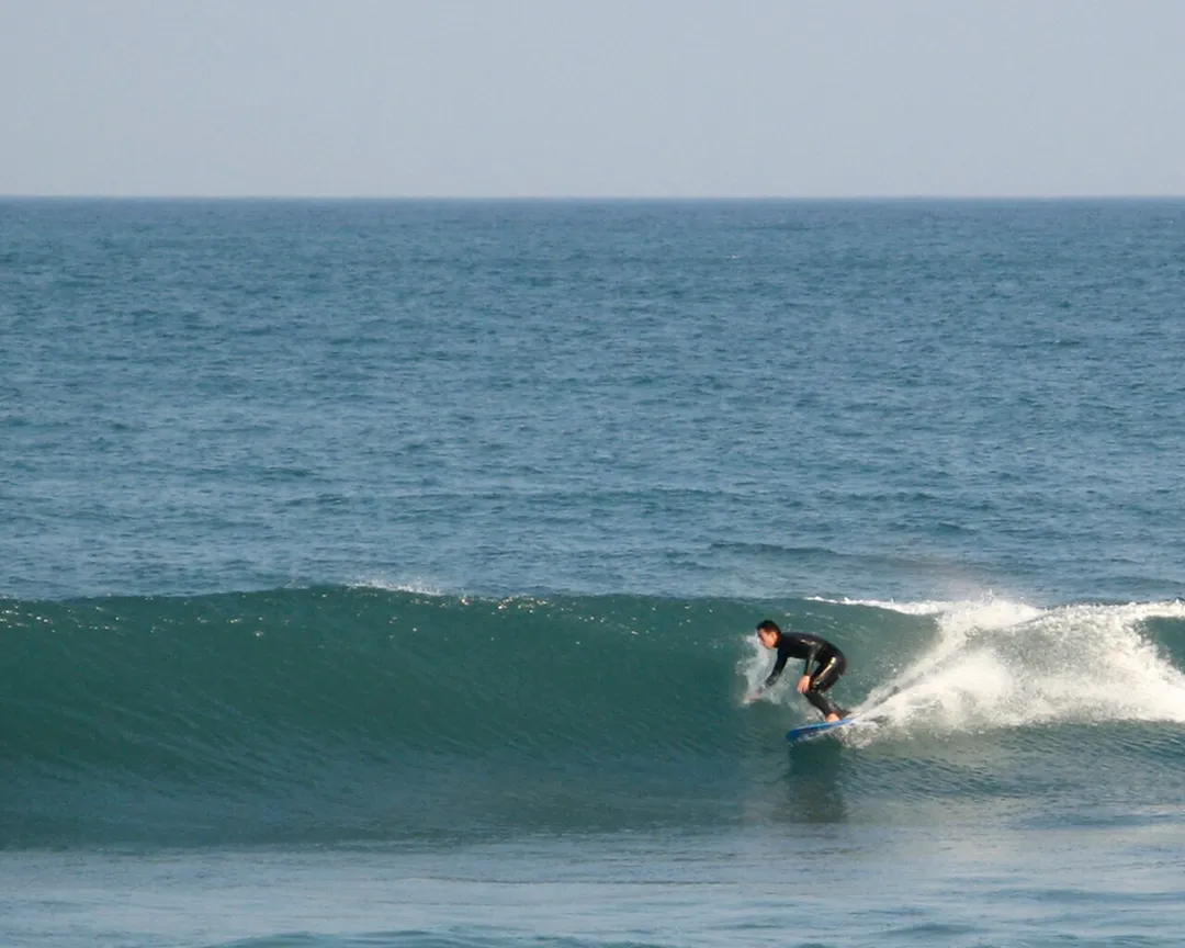A surfer with twin fin 5'6" off the coast of Minamibōsō, Chiba, Japan.