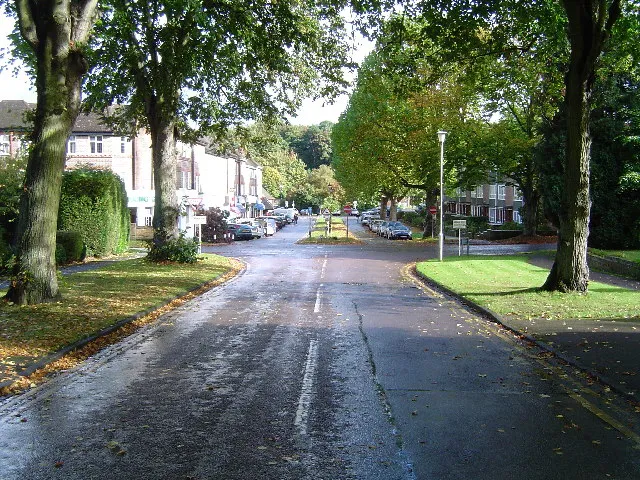 Rickmansworth: Main Avenue, Moor Park. 
Viewed looking downhill and eastwards towards the only shops in this exclusive housing estate.
Moor Park railway station is beyond the trees at the end of the road.