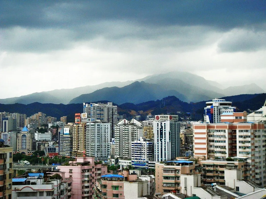 Buildings and mist on hills