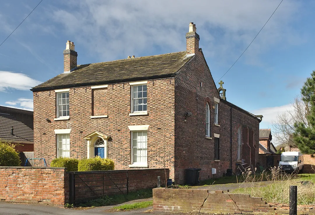 Corner view of St Benet's Chapel showing the non-obvious chapel to the rear, with its bell-cote.