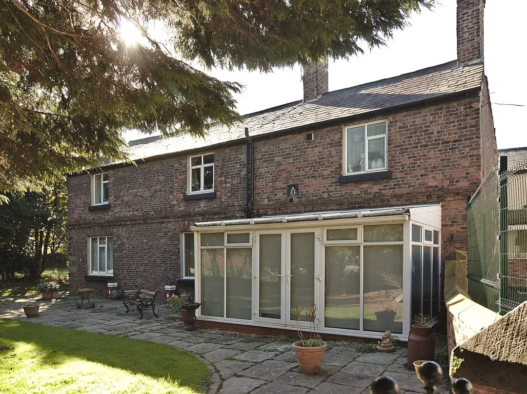 The original frontage of Brook Farmhouse, now its rear, with datestone of 1691.