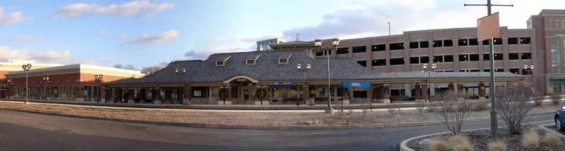 Panoramic image of the Oak Lawn Metra station, with the multi-story parking complex in the distance.