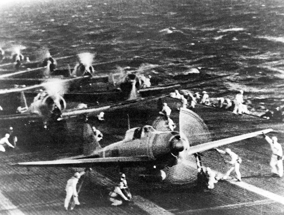 Photo #: . Pearl Harbor Attack, 7 December 1941. Japanese naval aircraft prepare to take off from an aircraft carrier (reportedly Shokaku) to attack Pearl Harbor during the morning of 7 December 1941. Plane in the foreground is a "Zero" Fighter, in front of "Val" dive bombers. This is probably the launch of the second attack wave.