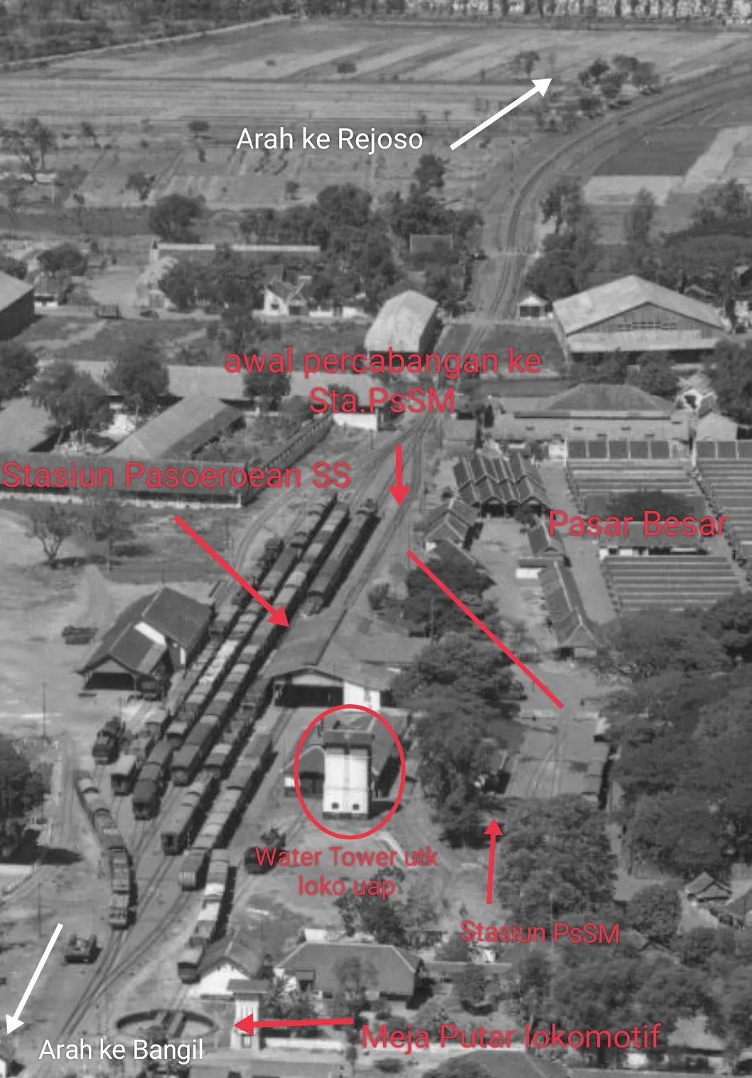 This was an aerial footage of Pasoeroean SS (read : Pasuruan) Railway Station from the west side showing some activities in 1947. It had facilities such as locomotive turntable, water tower as steam loco used it beside woods/coal as fuel and a locomotive workshop (?) (just to the left from water tower).This footage also showed the time that NV.PsSM (NV.Pasoeroean Stoomtram Maatschappij / Pasuruan Steam-Tram Co.) still existed which described with arrow (just right-bottom of Pasoeroean SS). The junction of PsSM line was from track/line one of Pasoeroean SS on eastern side (showed by red arrow stated "Awal Prcabangan ke Sta.PsSM) passing through behind Pasar Besar area and entered its own small station (just western side) showed in red straight slash line which has 3 rail tracks.