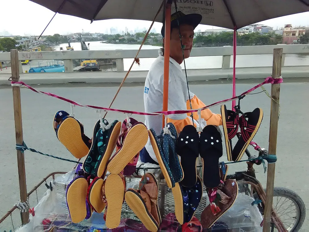 Man selling Alfombra -- a famous slipper made in Pateros, Metro Manila