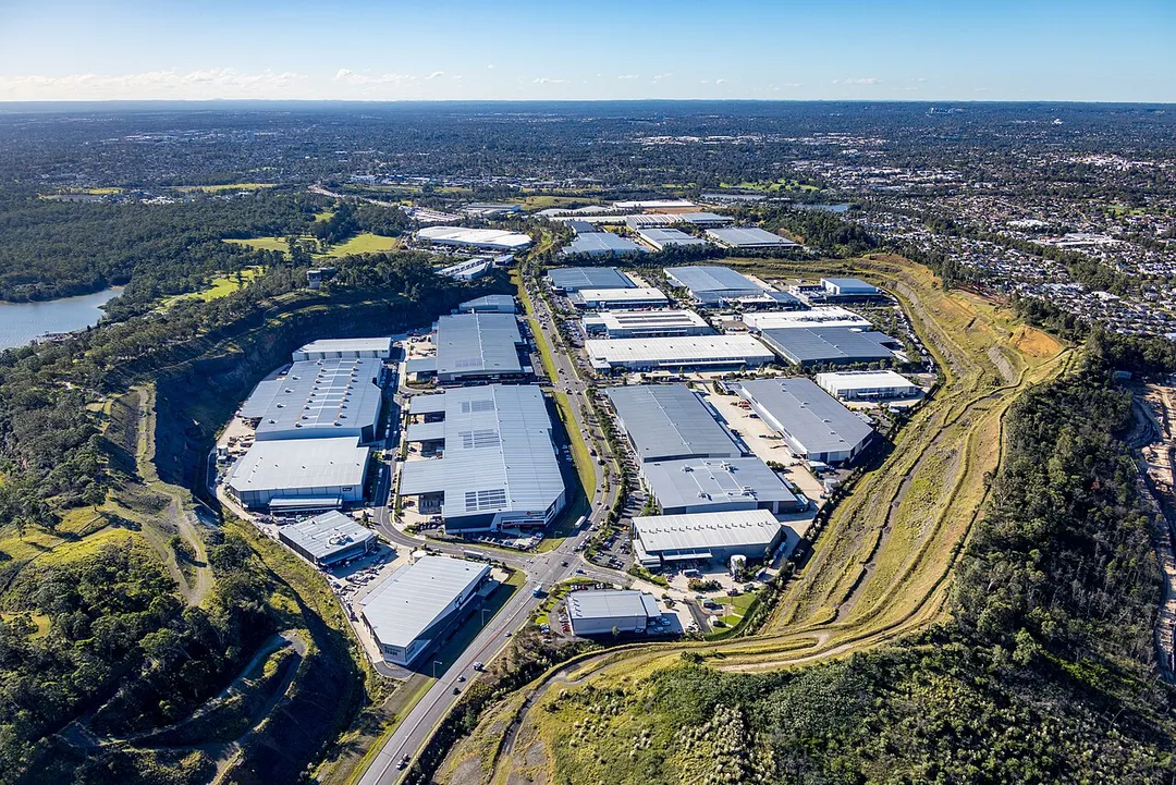 An aerial photo, taken from a helicopter. The industrial area of Pemulwuy in the western suburbs of Sydney Australia, was built in a previous quarry. 
This photo was taken looking south to north, from an altitude of 369m or approx 1200 feet.