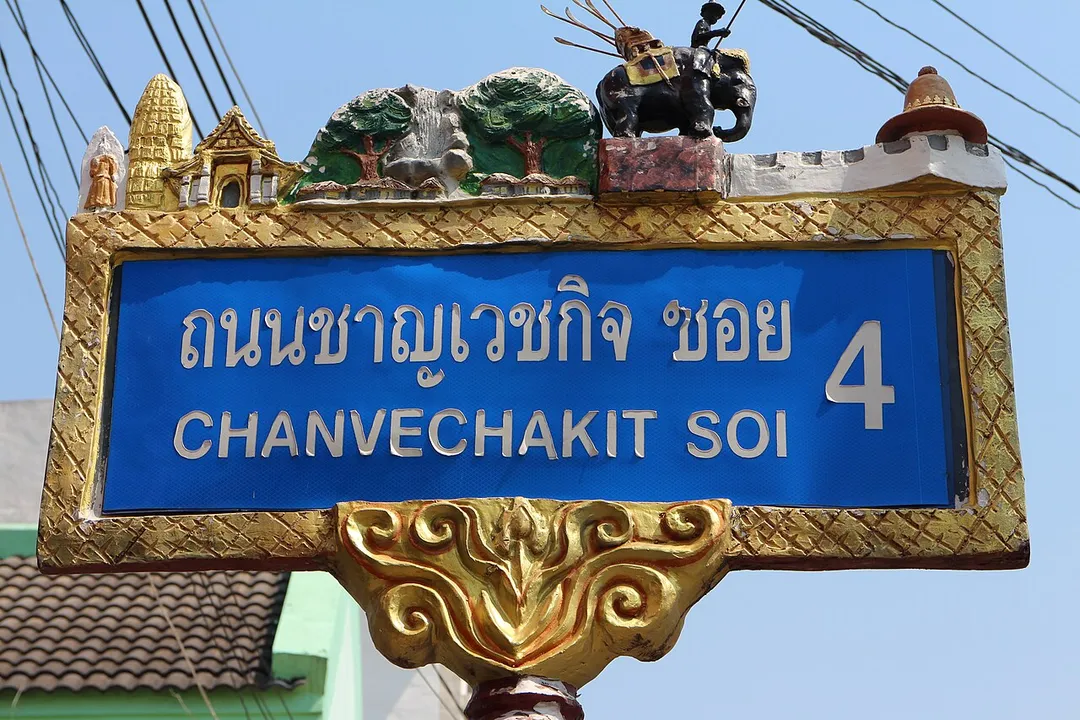 Decorated street sign up to the year 1999 in Phitsanulok City, Thailand. From left to right: three figures symbolize Wat Yai: Phra Attharot, a 9 meter high standing Buddha image, the 36 meter high prang and the entrance gate of Vihara Luang, which enshrines Buddha Chinnarat; a nature park with a waterfall; for houseboats on the Nan river; King Naresuan riding his war elephant; hat-shaped tower.