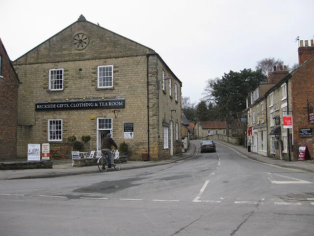 Bridge Street in the town of Pickering, North Yorkshire, England. The car is about to cross the bridge over Pickering Beck on other side of which (but not visible in this image) is Potter Hill. The Beckside gift shop and café is a former methodist chapel and temperance hall.