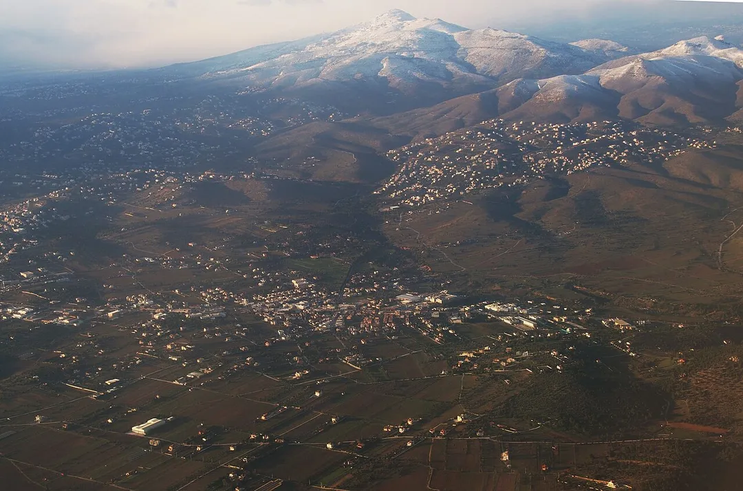 Airview of Pikermi at winter. Dioni is seen up left and Drafi up right, under the shadow of a cloud.