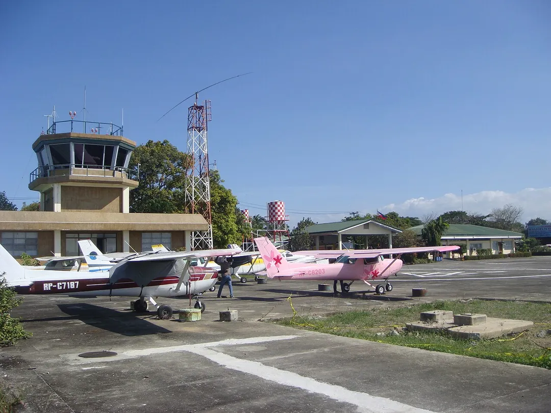 Control tower of the Airport, parked planes and aviation schools