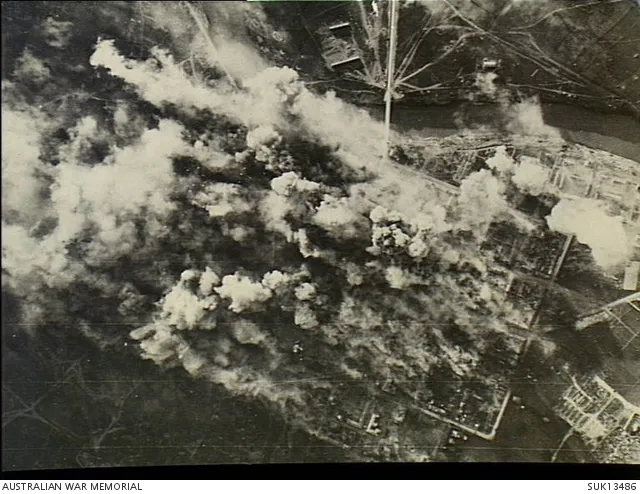 Strike photograph of the daylight attack by Liberator, Wellington and Halifax aircraft of the RAF on the Yugoslav town of Podgorica. German escort vehicles with troops escaping from Greece, were waiting in this town till darkness fell before fleeing northwards.
