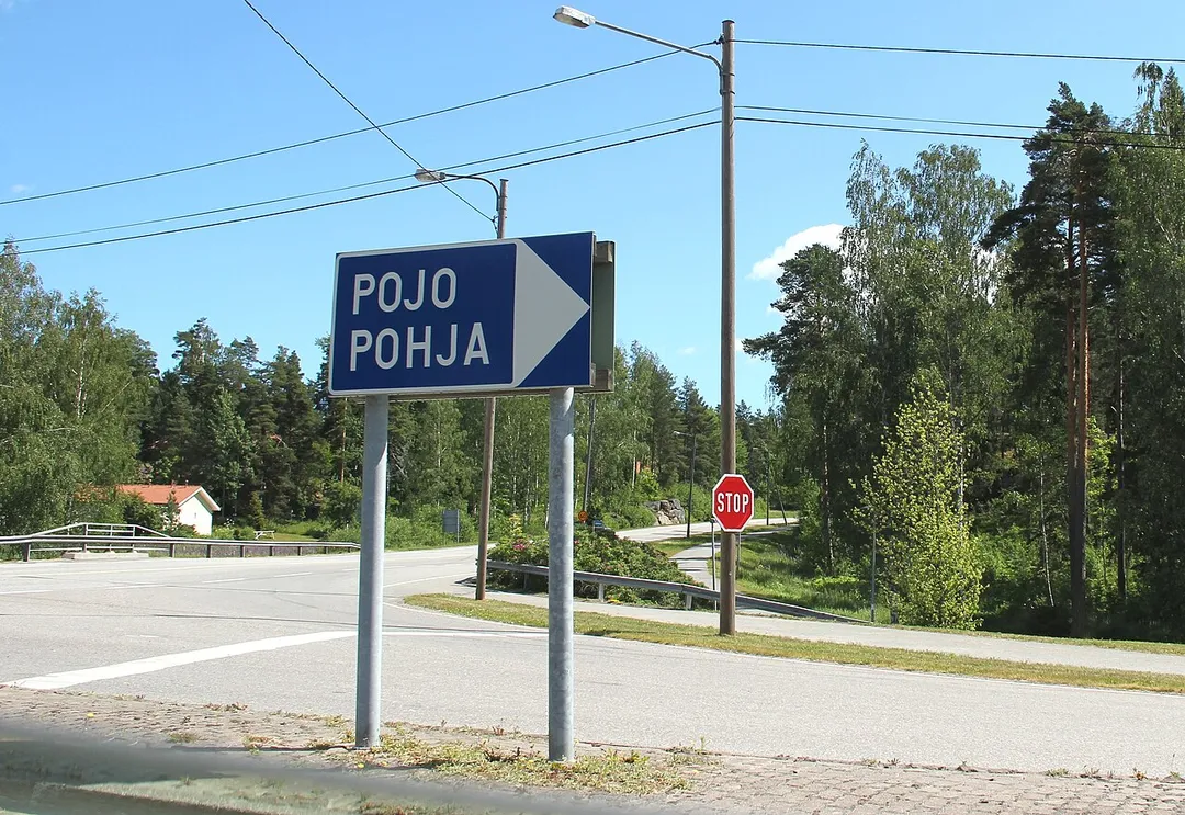 Risteys Pohjaan, kyltti, josta selviää, että kuntaliitoksen jälkeen pääkieleltään suomenkielisen Pohjan kylttien kielen vaihtuivat päinvastaisiksi.