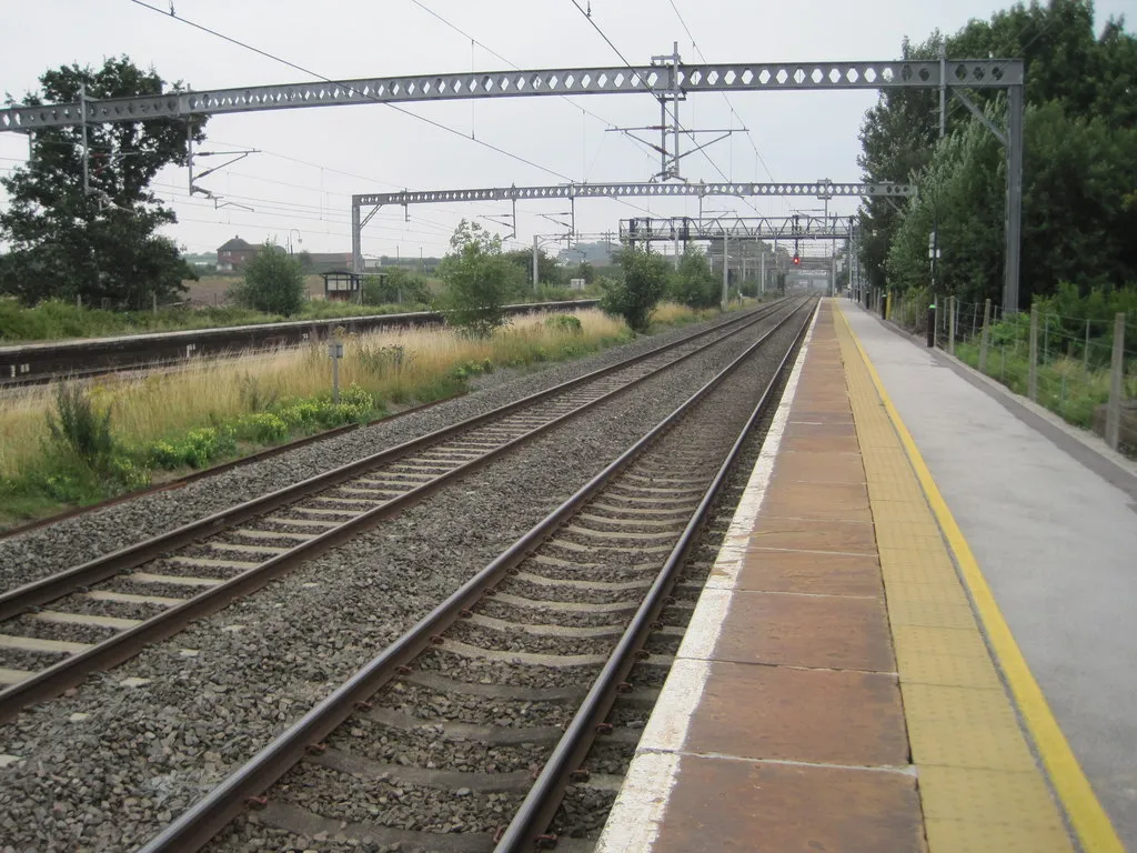 Polesworth station: Opened in 1847 by the London &amp; North Western Railway on the line from Rugby to Stafford, this station was reduced to just one northbound service per day when this image was taken. 
View south east towards Atherstone and Rugby. There was no access to the southbound platform (left) which was consequently overgrown! A platform shelter can be seen in the undergrowth - which was actually the only shelter on the whole station.