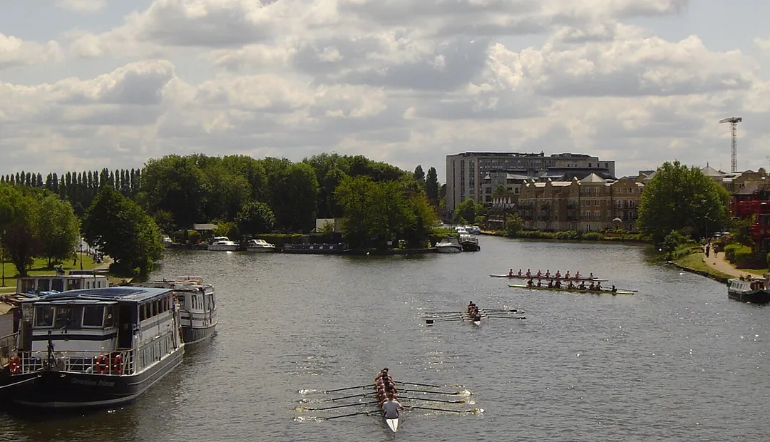 The River Thames, looking downstream from Caversham Bridge in the English town of Reading. Pipers Island and its restaurant is to the immediate left, the upstream end of Fry's Island can be seen downstream separating the two channels.  For more information see the Wikipedia articles Pipers Island and Fry's Island.