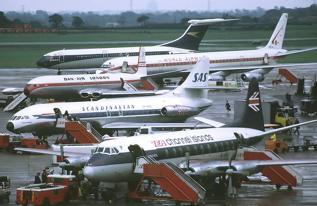 From front to back: BEA Vickers 802 Viscount (G-AOHT), SAS Scandinavian Airlines Sud SE-210 Caravelle III (OY-KRC), Dan-Air London De Havilland Comet 4 (G-APDD), World Airways DC-8 (?) and BOAC Vickers VC10. Manchester Airport
