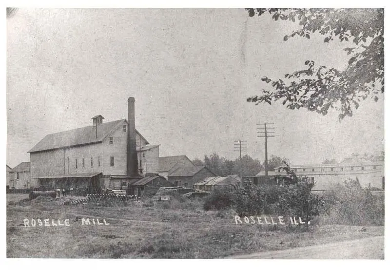 Roselle Mill in Roselle, Illinois. The given notes state: "(Roselle Flour and Feed Mill. Photo marked 1895. Little difference between this photo and photos of the mill that was rebuilt after the fire of 1916.) In 1890, John C. Hattendorf built a grain mill along the north side of the railroad tracks between Prospect Street and Roselle Road. The owners of the mill were: Hattendorf, William Fenz, Herman Schmoldt, H. Turner, J. F. O'Day; rented to Robert Schulze."