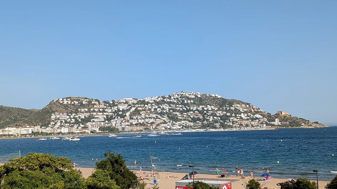 The view is from the north-west.
The summit of Puig Rom (altitude 225 metres) is to the right, where there is a pylon.

The slightly lower summit, on the left, is the Puig de les Muralles (187 metres). On that summit are located the remains of a large 7th-8th century Visigothic fortified settlement.