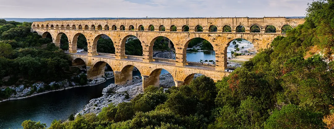 Pont du Gard, in Vers-Pont-du-Gard, Gard department, South France. The Pont du Gard is the most famous part of the roman aqueduct which carried water from Uzès to Nîmes until roughly the 9th century when maintenance was abandoned. The monument is 49m high and now 275m long (it was 360m when intact) at its top. It's the highest roman aqueduct, but also one of the best preserved (with the aqueduct of Segovia). The Pont du Gard has been a UNESCO world heritage site since 1985.
