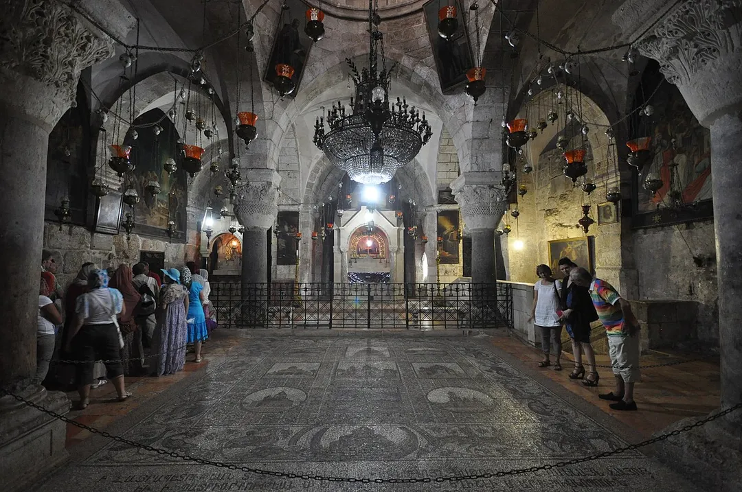 The Chapel of Saint Helena is a 12th-century Armenian church in the lower level of the Church of the Holy Sepulcher in Jerusalem.
In the south east of the chapel there is a chair which was reputed to be a seat that was sat in by Saint Helena, the mother of the Emperor Constantine when she was looking for the True Cross. There are two apses in the church, one dedicated to Saint Helena and one to the penitent thief on the cross. The chapel is modestly adorned in memory of Saint Helena's simplicity.
The chronicler William of Tyre reports on the renovation of the Church of the Holy Sepulcher in the mid-12th century. The crusaders investigated the eastern ruins on the site, occasionally excavating through the rubble, and while attempting to reach the cistern where the True Cross was believed to have been found, they discovered part of the original ground level of Hadrian's temple enclosure; they decided to transform this space into a chapel dedicated to Helena, widening their original excavation tunnel into a proper staircase.
During 1973–1978 restoration works and excavations were made on the Holy Sepulchre To the east of the Chapel of St. Helena, the excavators discovered a void containing a 2nd-century drawing of a roman ship, two low walls which supported the platform of Hadrian's 2nd-century temple, and a higher 4th century wall built to support Constantine's basilica; the Armenian authorities have recently converted this archaeological space into the Chapel of Saint Vartan, and created an artificial walkway over the quarry on the north of the chapel, so that the new Chapel could be accessed (by permission) from the Chapel of St. Helena.
The Church of the Holy Sepulchre
The Church of the Holy Sepulchre, also called the Basilica of the Holy Sepulchre, or the Church of the Resurrection by Eastern Christians, is a church within the Christian Quarter of the walled Old City of Jerusalem. It is a few steps away from the Muristan.
The site is venerated as Golgotha (the Hill of Calvary), where Jesus was crucified, and is said also to contain the place where Jesus was buried (the Sepulchre). The church has been a paramount – and for many Christians the most important – pilgrimage destination since at least the 4th century, as the purported site of the resurrection of Jesus. Today it also serves as the headquarters of the Greek Orthodox Patriarch of Jerusalem, while control of the building is shared between several Christian churches and secular entities in complicated arrangements essentially unchanged for centuries. Today, the church is home to branches of Eastern Orthodoxy and Oriental Orthodoxy as well as to Roman Catholicism. 

Anglican and Protestant Christians have no permanent presence in the Church – and some have regarded the alternative Garden Tomb, elsewhere in Jerusalem, as the true place of Jesus's crucifixion and resurrection [Wikipedia.org]