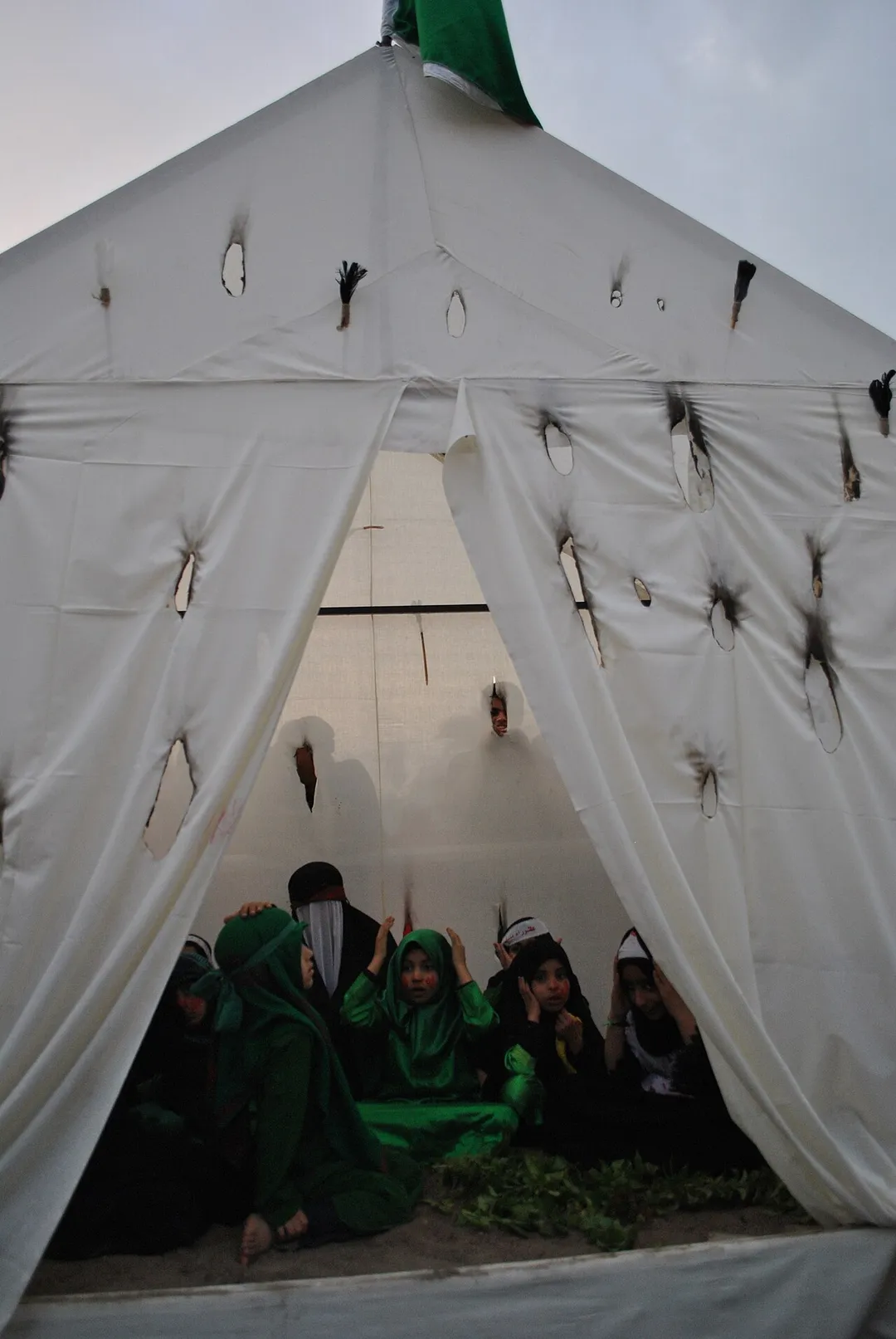 Bahraini Shia Muslims carry-out a theatrical performance to recreate the martyrdom of Imam Hussain in Sanabis, Bahrain. (5)