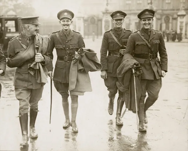Second Lieutenant (2nd Lt) Arthur Seaforth Blackburn VC, 10th Battalion (second from left), walking down a road with fellow soldiers after his investiture by King George V at Buckingham Palace. 2nd Lt Blackburn was awarded the Victoria Cross for his actions and gallantry at Pozieres, France, on 23 July 1916. Captain W.F.J. McCann MC is at right front