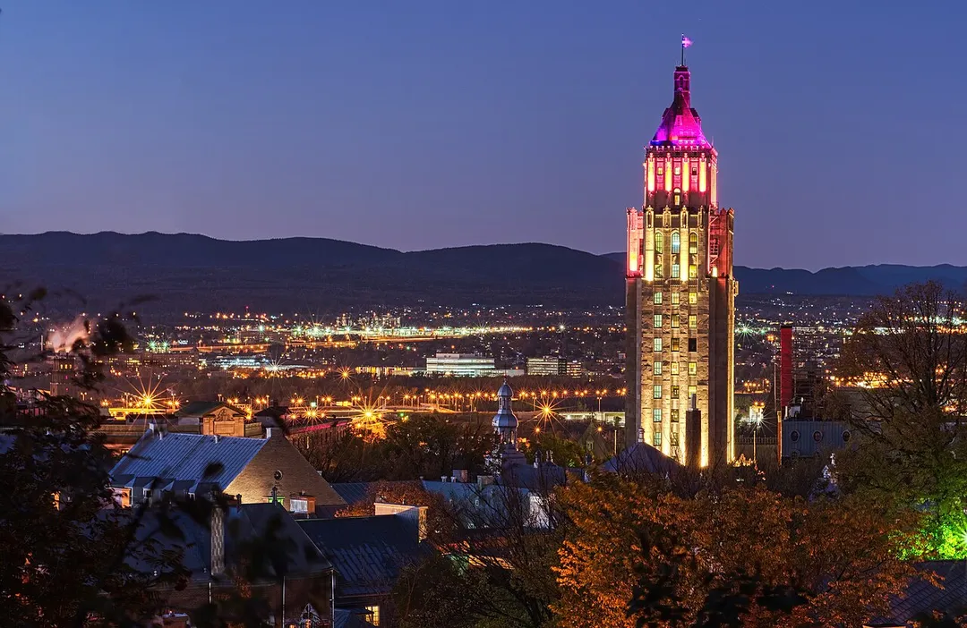The Price Building illuminated at night in Quebec City.