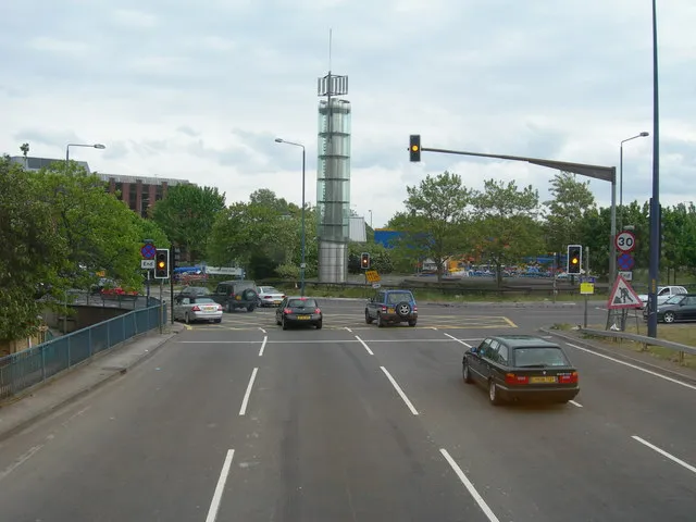 A3220 Approaching the Holland Park Roundabout Approaching the Holland Park Roundabout and heading south. Left for Holland Park, right for Shepherds Bush and ahead for Earls Court. The tower is called the Thames Water Tower. 
This could not usually be photographed from this angle and this range as there are no overbridges anywhere along here that a pedestrian can use, and pedestrians and cycles are not permitted on the road itself. This photo was done from the top deck of a number 220 bus which was on diversion from its normal route along Wood Lane.