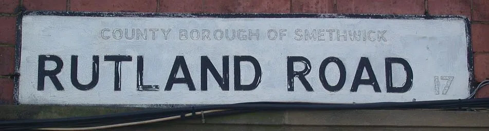 Street nameplate on Rutland Road, Smethwick, West Midlands, England, showing painted out "County Borough" lettering. April 2007