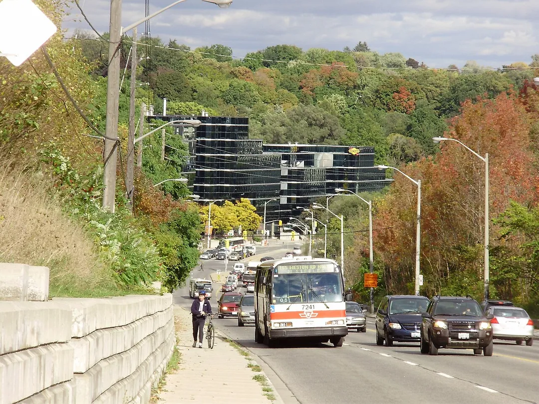 Looking east along Wilson Avenue as it enters the neighbourhood of Hoggs Hollow, specifically the intersection of Yonge Street and Wilson Avenue/York Mills Road, in Toronto, Ontario, Canada. The black building is the York Mills Centre.