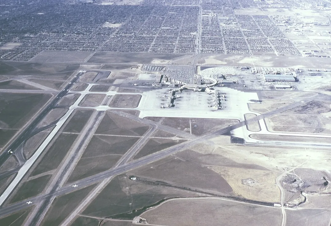 Aerial view of the old Denver Stapleton Airport.  Looking from East to the West, showing Runways 26L and 26R, R35, and the Terminal Building with Concourses A, B, &amp; C.