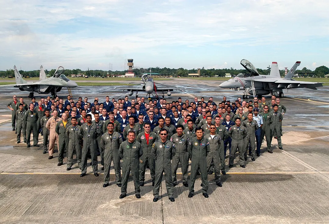 040715-N-0493B-040 Kuantan, Malaysia (July 15, 2004) - Crew and pilots assigned to Strike Fighter Squadrons (VFA) 102, 192 and 195 pose with counterparts from the Royal Malaysian Air Force's (RMAF) No. 6, 17 and 19 Squadrons in front of an RMAF MiG-29 Fulcrum, left, an RMAF MK 208 Hawk, center and a U.S. Navy F/A-18F Super Hornet during an aircraft display and photo session that wrapped up a 10-day combined air exercise. Air-to-air combat between F/A-18Fs, F/A-18Cs and the RMAF aircraft, along with a variety of symposiums took place during the exercise, which was part of the Malaysia phase of the Cooperation Afloat Readiness and Training (CARAT) exercise series. CARAT is a regularly scheduled series of bilateral military training exercises with several Southeast Asia nations designed to enhance the interoperability of the respective sea services. U.S. Navy photo by Lt. Chuck Bell (RELEASED) For more information go to: www.clwp.navy.mil/carat2004/