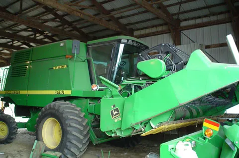 A 9410 John Deere Combine harvester that belongs to my Dad is shown here. As shown in this photo, it is currently set up to combine oats. There is another head that combines corn that we have. I took this photo in July of 2004.