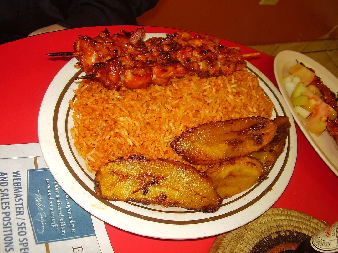 Shrimp suya with jollof rice and plantains