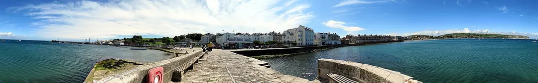 The seafront at Swanage in ultrawide panorama, taken from the end of a peer.
