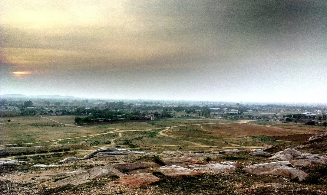 This is a photo of Tauru City this red building ahead is D.P.S. Mewat Model School Tauru, and this pic was taken from hill of 'Aravalli Range', using HTC Desire 501.