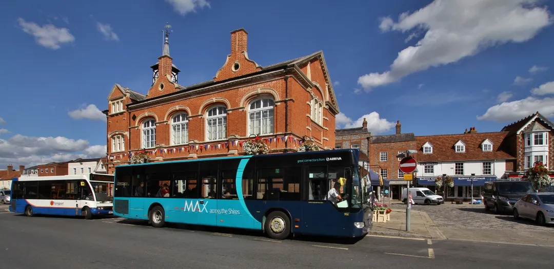 An Arriva the Shires bus on route 280 outside the Town Hall in High Street, Thame, Oxfordshire. The bus is a Mercedes-Benz Citaro, registration mark BD12 DHK, fleet number 3932. Behind it is a Z&amp;S Transport bus on route 113. It is an Optare Solo, registration mark MX03 YDE.