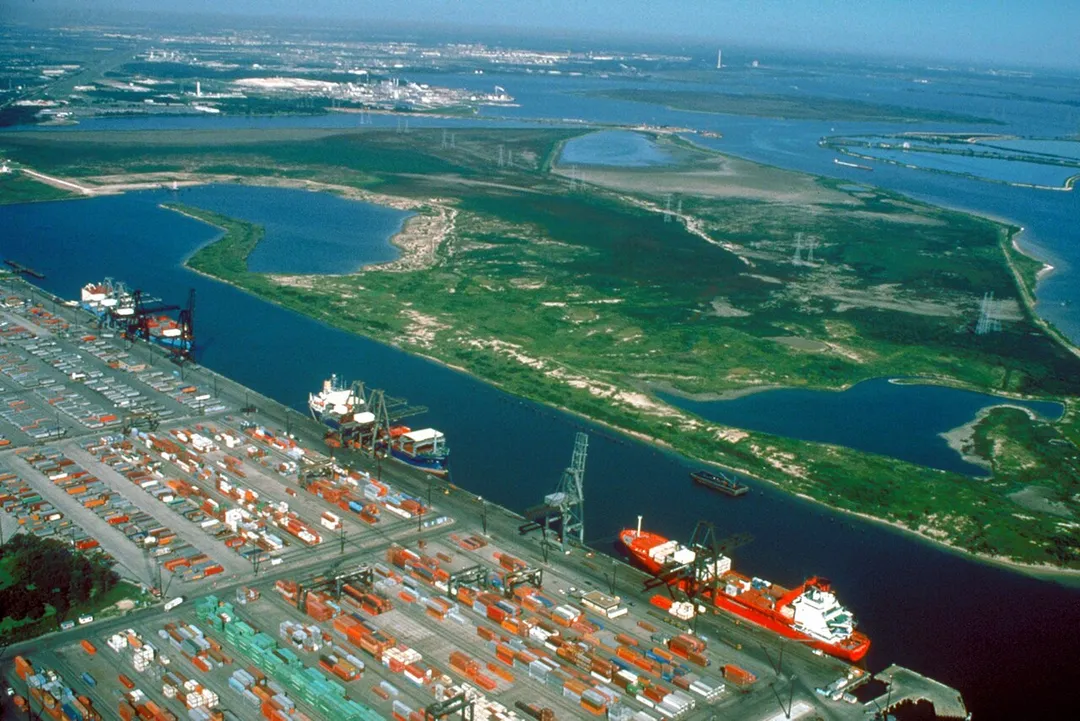 Aerial view of the Barbour's Cut area on the Houston Ship Channel in Houston, Texas, USA. This area is a large container terminal. This photograph appears to have been taken before the Fred Hartman Bridge was built, or when the bridge was under construction. In a present-day photograph, the bridge should be clearly visible at top right.