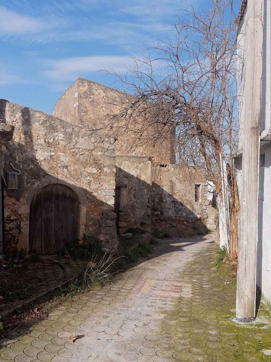 A street in Thrapsano, Crete, with traditional stone houses.