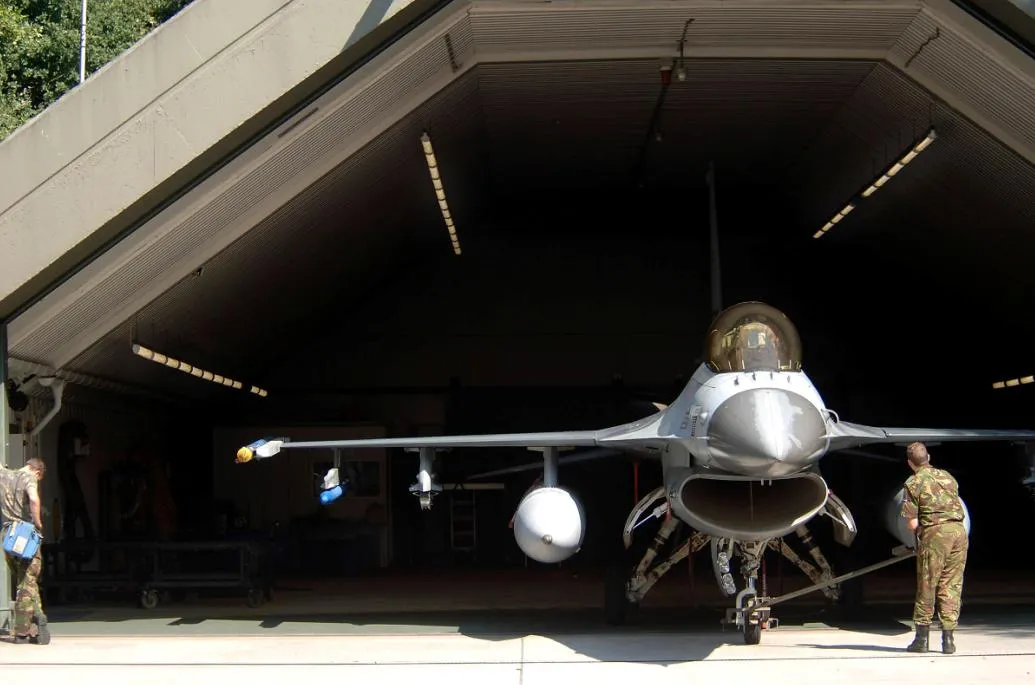 VOLKEL AIR BASE, Netherlands -- Dutch air force Sgt. Martijn De Boer (left) and Cpl. Jordy Luske tow a 306th Tactical Fighter Training Squadron F-16 Fighting Falcon into a hangar here. The plane returned from a training flight with Lt. Col. David Stein, an Air Force exchange pilot, at the controls. The colonel, from the Arizona Air National Guard's 162nd Fighter Wing at Tucson, Ariz., is ending a three-year tour with the Dutch air force's 1st Fighter wing. The Dutch airmen are crew chiefs. (U.S. Air Force photo by Senior Master Sgt. Keith Reed)