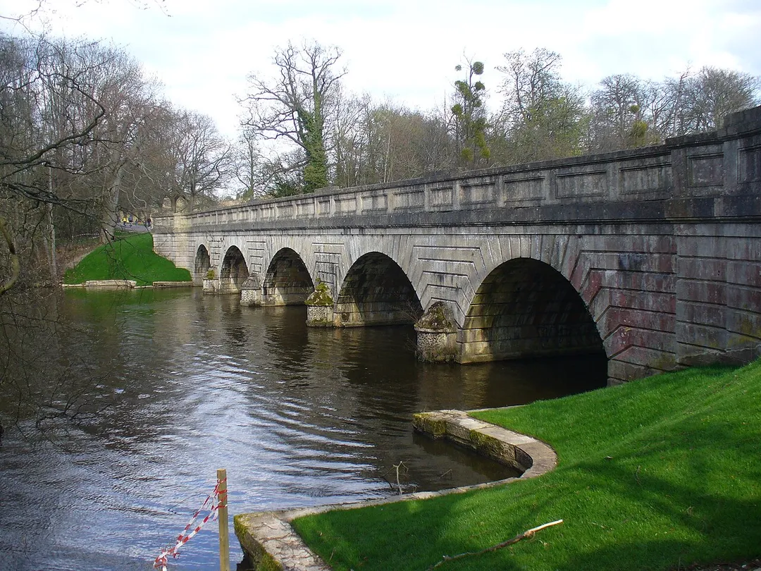 Five Arch Bridge West side of the ornate and sturdy stone bridge built in 1822-27 by Sir Jeffry Wyatville. Two earlier bridges stood here at the west end of Virginia Water.
http://www.theroyallandscape.co.uk/